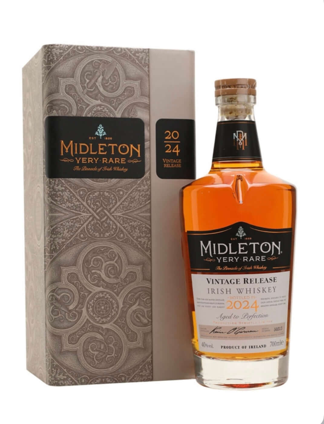 Midleton Very Rare Vintage Release 2024 Irish whiskey presented in its elegant gift box alongside the bottle. The tall, rectangular box features a sophisticated grey and silver ornate Celtic-inspired pattern with a prominent black label reading "MIDLETON VERY RARE" in gold lettering, "ESTD 1984", and "The Pinnacle of Irish Whiskey". A side panel shows "2024 VINTAGE RELEASE" in gold.