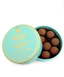 Open teal tin of milk chocolate truffles with 'Charbonnel et Walker' branding on a white background.