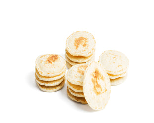 Stack of thin pancakes on a white background