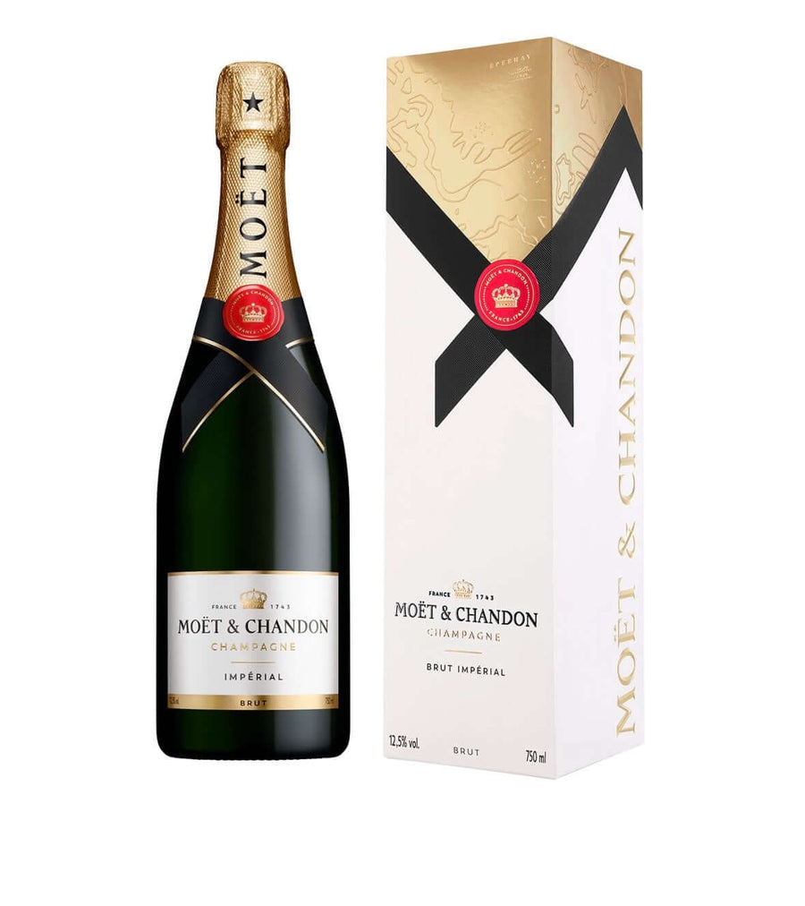 A bottle of Moët & Chandon Impérial Brut Indépendant champagne next to its white and gold presentation box, set against a plain white background.