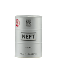 White cylindrical metal barrel-shaped bottle of NEFT premium Austrian vodka, mimicking an oil drum design. The barrel features bold black text: "NEFT" prominently in the center band, "VODKA" below it, and "700 ml e • Alc. 40% Vol." at the bottom. Additional text includes "CRAFTED IN AUSTRIA"