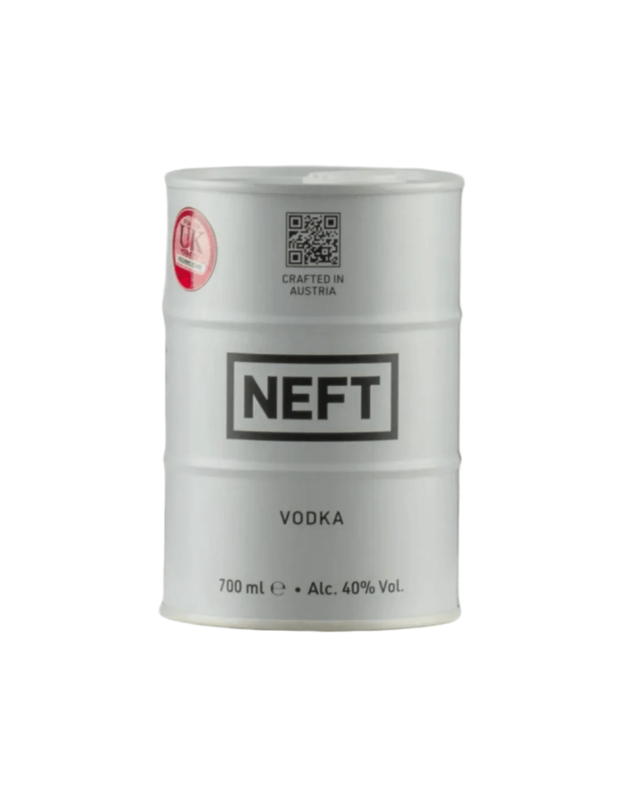 White cylindrical metal barrel-shaped bottle of NEFT premium Austrian vodka, mimicking an oil drum design. The barrel features bold black text: "NEFT" prominently in the center band, "VODKA" below it, and "700 ml e • Alc. 40% Vol." at the bottom. Additional text includes "CRAFTED IN AUSTRIA"
