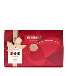 Red Neuhaus chocolate box with a bow on a white background
