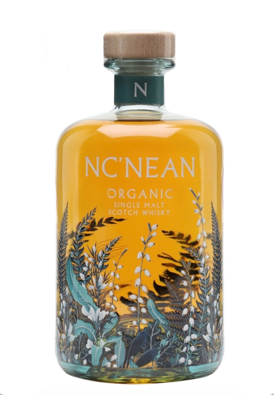 A bottle of NC'NEAN Organic Single Malt Scotch Whisky with a golden amber liquid, featuring botanical illustrations in teal, black, and white on the lower half, and a light wood cap.