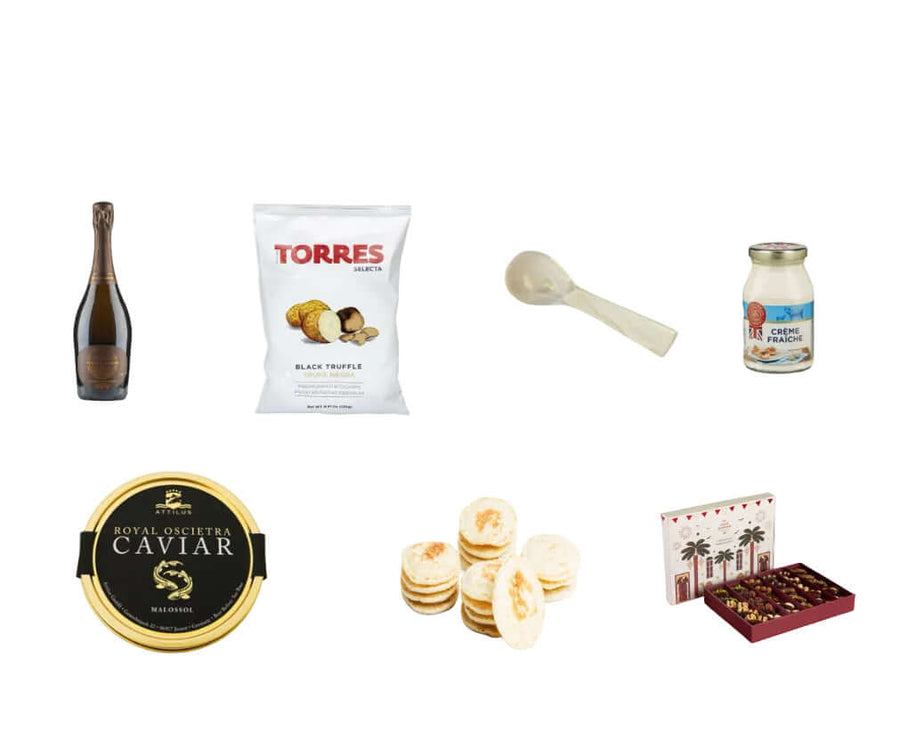 Collection of gourmet items including an alcohol free bottle of Sparkling wine, Caviar, Qinwan Dates and other food products on a white background.