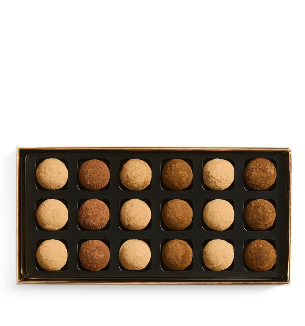 Box of assorted truffles on a white background