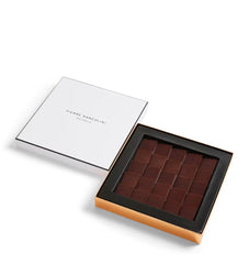 Box of chocolates with a white lid and brown base on a white background