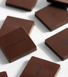 Dark chocolate bars with 'Madagascar' branding on a white surface