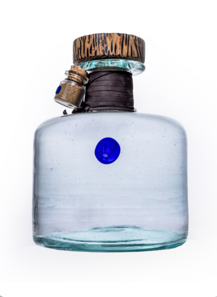 Blue glass bottle with wooden cap on a white background