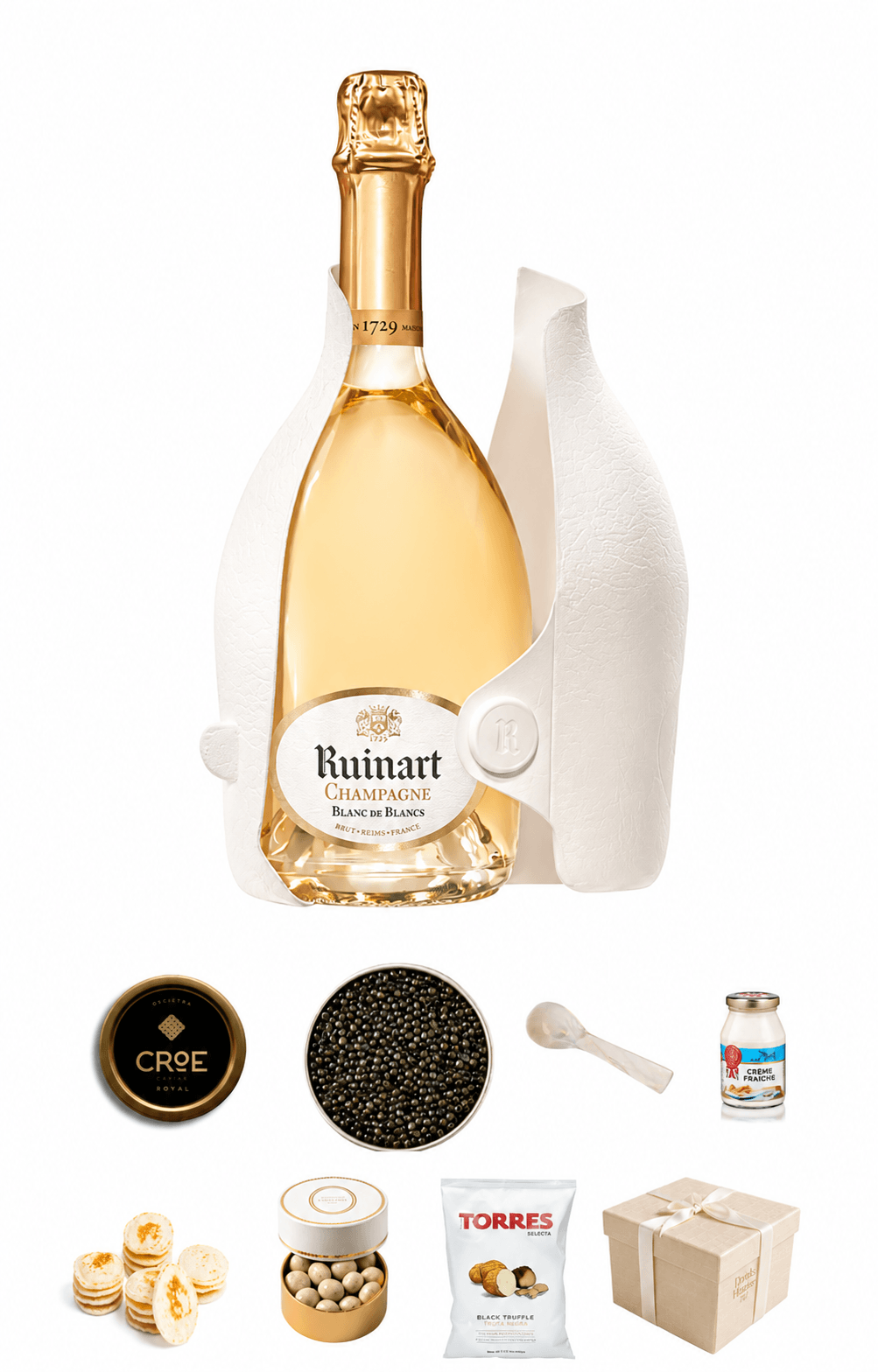 Bottle of Ruinart champagne with caviar, nuts, and other items on a white background