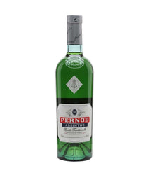 A green glass bottle of Pernod Absinthe with a white and red label, sealed with a silver cap, shown against a plain white background.