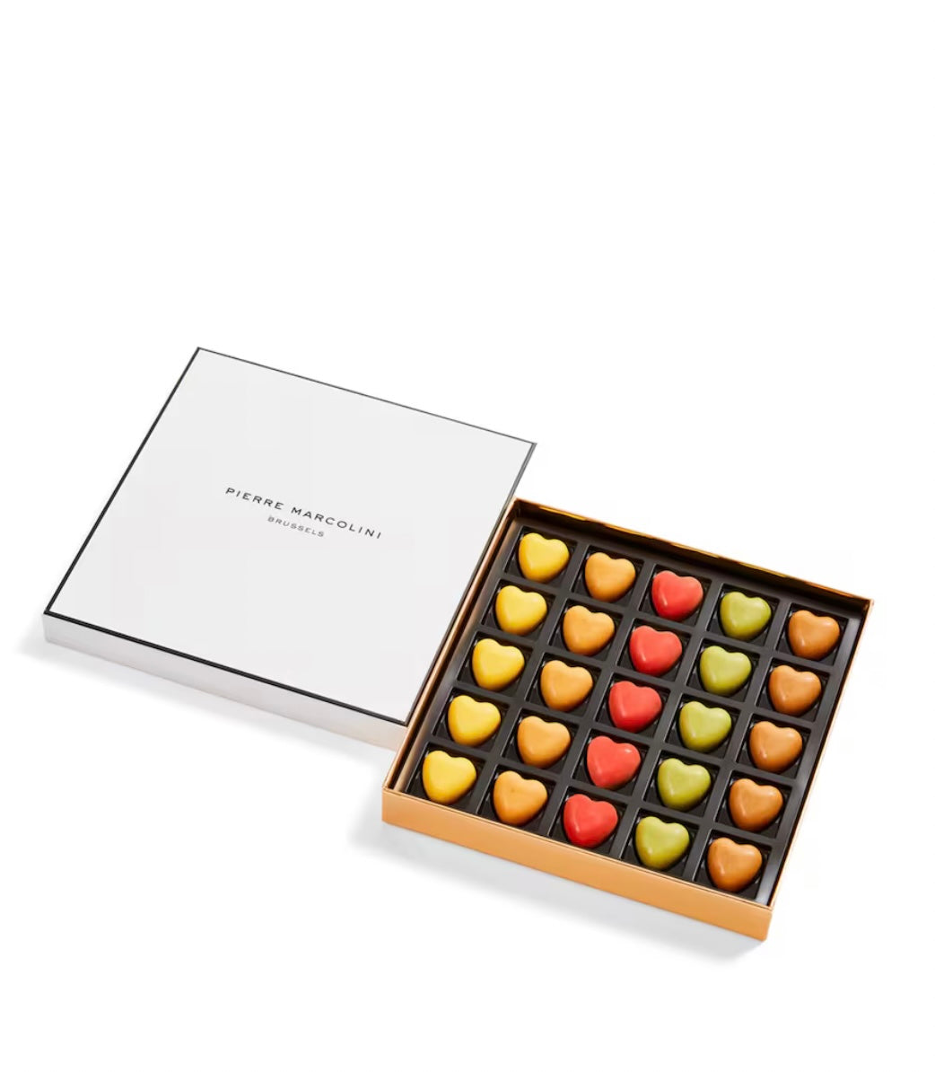 Box of colorful heart-shaped chocolates by Pierre Marcolini on a white background