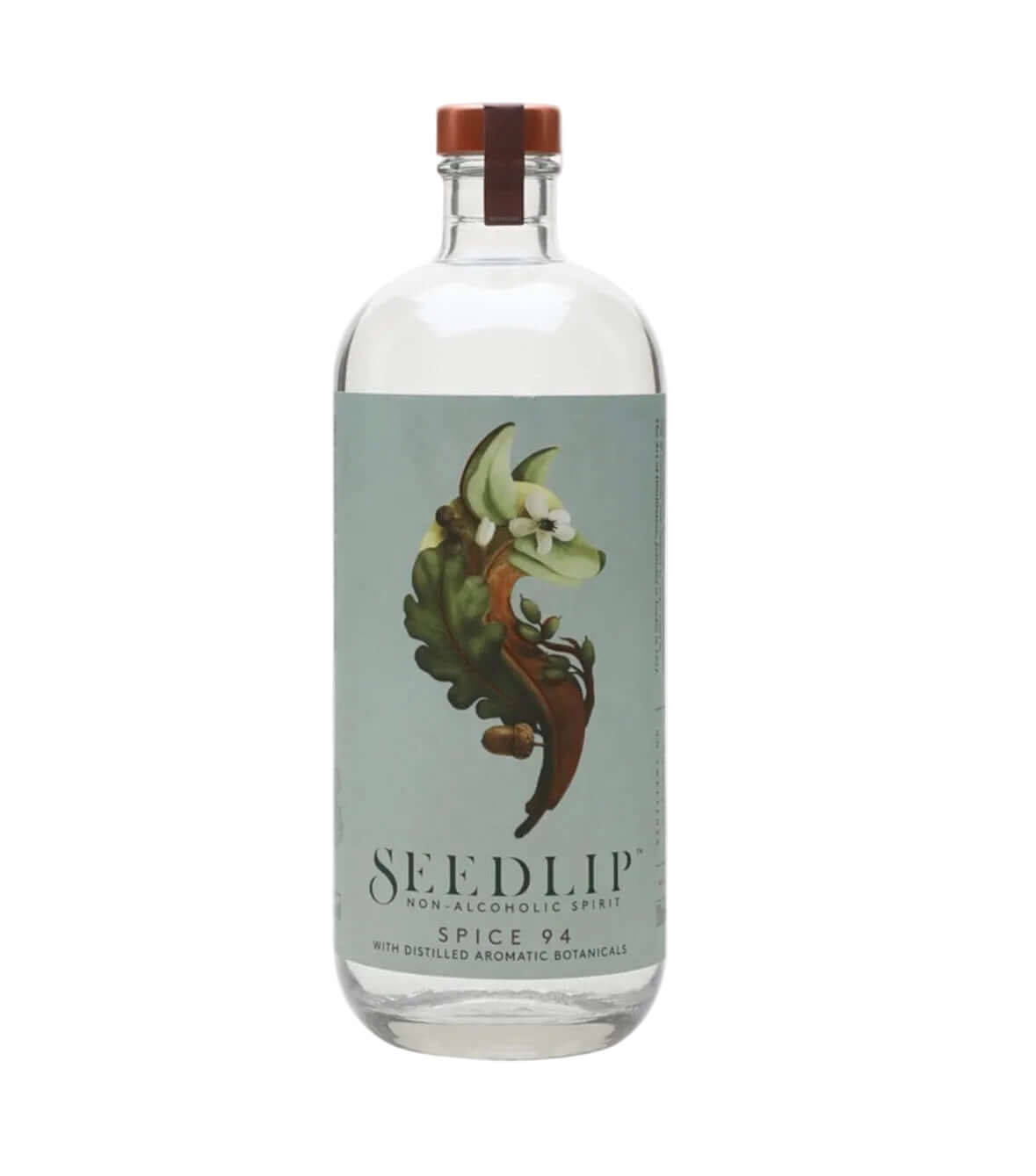 A clear glass bottle of Seedlip Non-Alcoholic Spice 94 gin with a light blue-green label featuring a botanical illustration of a cinnamon stick and a brown cap, on a white background.