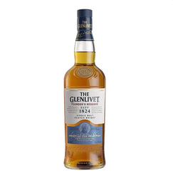 Tall, clear glass bottle of The Glenlivet Founder's Reserve single malt Scotch whisky with rich golden-amber liquid. The bottle features a dark blue foil capsule at the top with gold embossed text "THE GLENLIVET". The main label has a clean white background with gold and blue accents: "THE GLENLIVET" in large gold lettering at the top, "FOUNDER'S RESERVE" below, and "SINGLE MALT SCOTCH WHISKY" in smaller text.