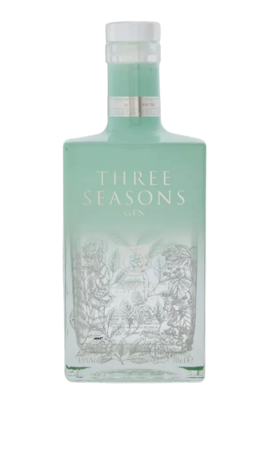 Pale mint-green square glass bottle of Cambridge Three Seasons Gin (70cl), filled with clear gin that takes on a subtle greenish tint from the glass. The bottle has a clear glass stopper cap and a delicate label design in white and mint tones: "THREE SEASONS GIN" in elegant uppercase letters across the center, a circular Cambridge Distillery emblem with a stylized "C" and botanical motifs