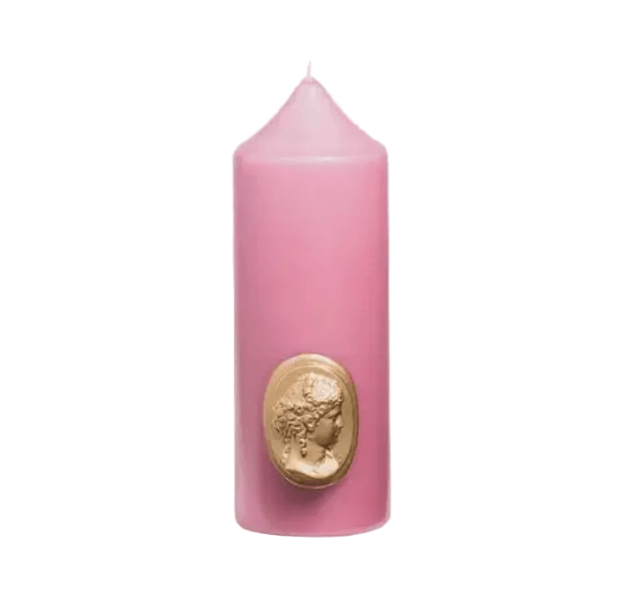 Pink candle with a gold emblem on a white background