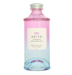 Pink-to-clear gradient glass bottle of Ukiyo Japanese Blossom Gin (700ml / 70cl). The bottle has a cylindrical shape with a rounded base and a silver screw cap. The label is a clean white rectangle with pink and black text: "浮世" (Ukiyo) in pink at the top, "UKIYO" in large black letters, "JAPANESE BLOSSOM GIN" below, followed by "700ml e ~ 40% ALC./VOL.”