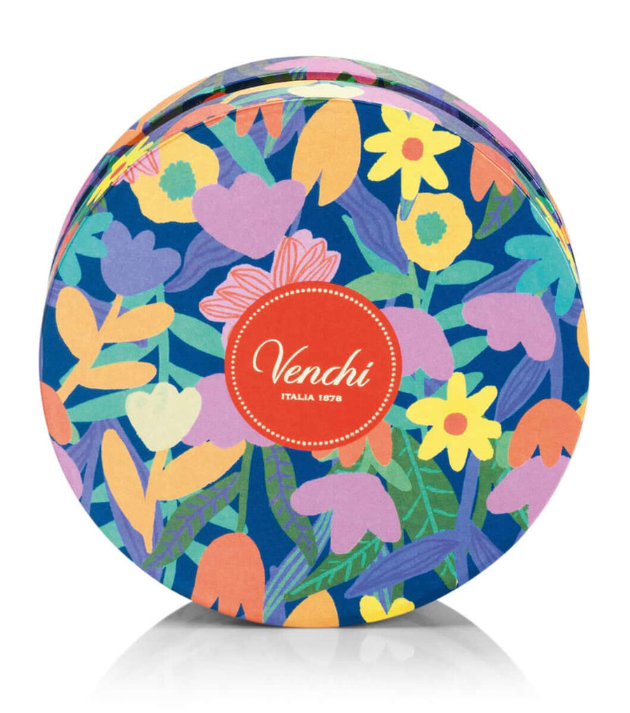 Colorful floral-patterned chocolate tin with 'Venchi' logo on a white background
