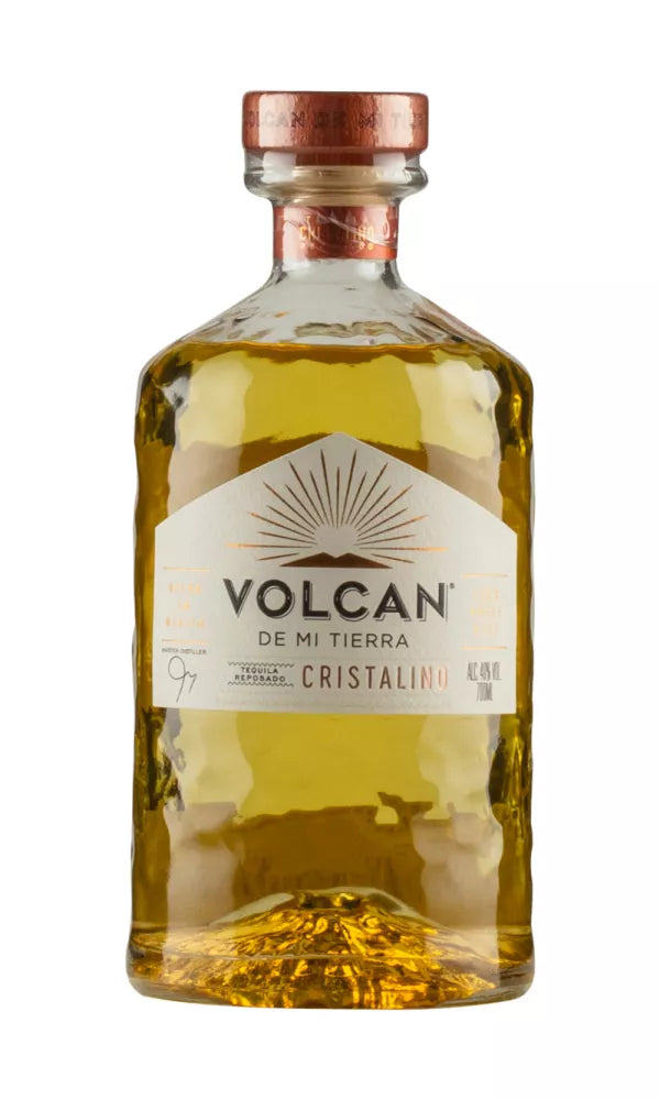 Sleek 70cl bottle of Volcan De Mi Tierra Añejo Cristalino Tequila, 40% ABV, with a volcanic-inspired design. This clear tequila blends rich agave, caramel, and oak flavors.