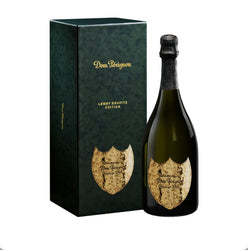 Dom Pérignon Lenny Kravitz Limited Edition Vintage 2008 Champagne bottle in a dark green gift box with gold “Dom Pérignon” and “Lenny Kravitz Edition” lettering, featuring the bottle with a textured hammered metal label.