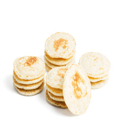 Stack of thin pancakes on a white background