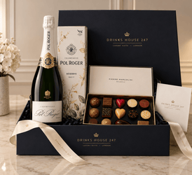 The Pol Roger & Marcolini Hamper in a black and gold Drinks House 247 gift box, holding Pol Roger Reserve Brut Champagne 75cl with its floral gift carton and an open Pierre Marcolini chocolate selection box, with a cream hand-tied ribbon and message card